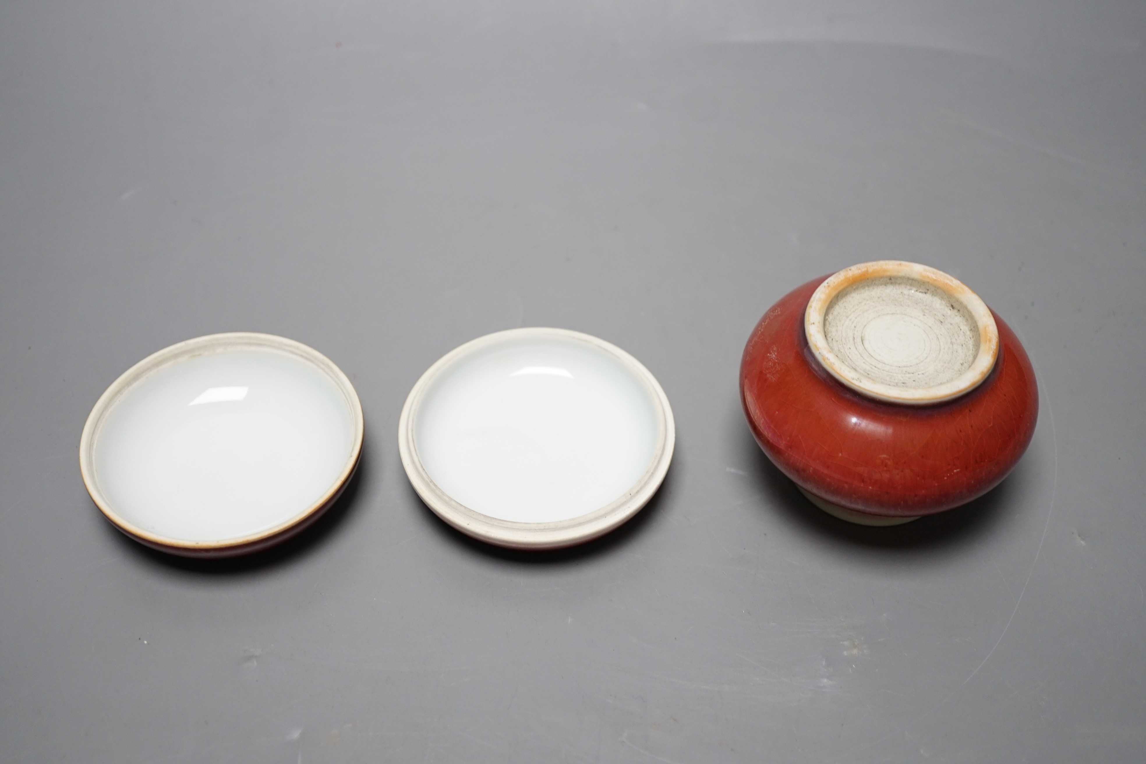 A Chinese sang de boeuf glazed seal paste box and a small pot (2) box 7.5cm diameter